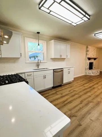 a kitchen with a sink cabinets and window