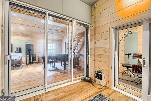 a view of entryway and hall with wooden floor