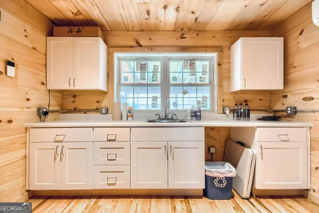 a spacious bathroom with double vanity and a bathtub