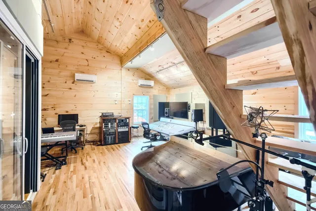 a room with furniture a large window and wooden floor