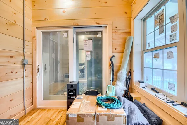 a very nice looking room with a glass door and furniture