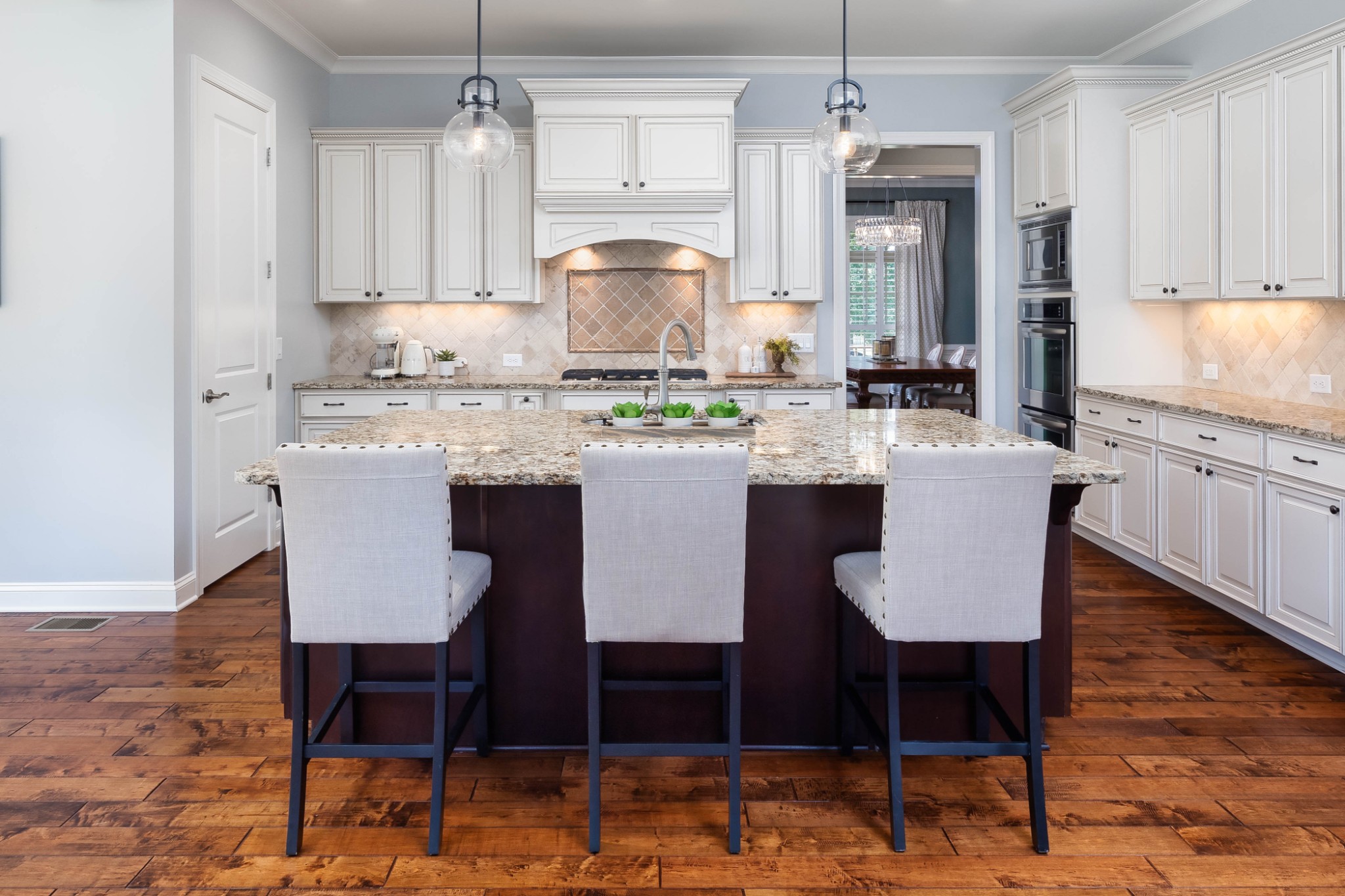 1828 Kettering Trace Brentwood, TN 37027 - Photo 11 of 62 a kitchen with kitchen island granite countertop a dining table chairs and white cabinets
