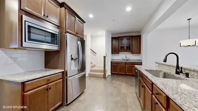 a bathroom with a sink toilet double vanity and shower