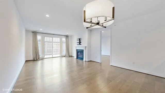 a view of a dining room with furniture a chandelier and wooden floor