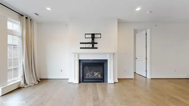 a large kitchen with stainless steel appliances granite countertop a sink dishwasher a stove and a refrigerator with wooden floor