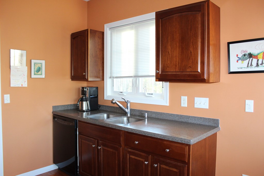 101 Buttercup Lane, Unit 101 Grafton, MA 01560 - Photo 13 of 24 a kitchen with a sink cabinets and a window