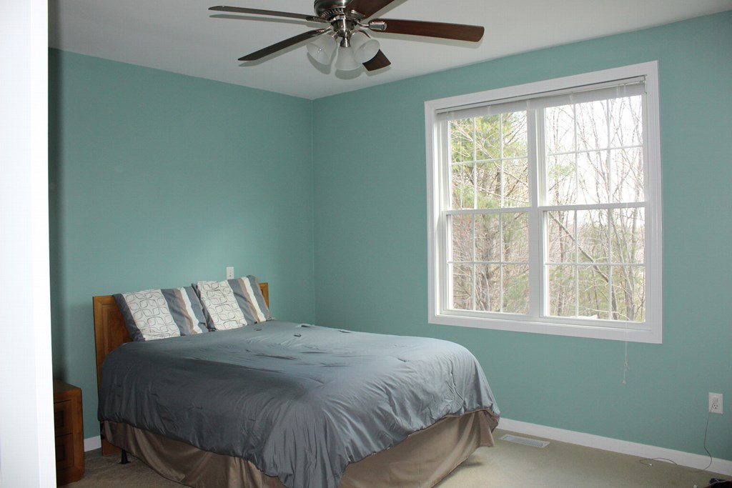 101 Buttercup Lane, Unit 101 Grafton, MA 01560 - Photo 15 of 24 a bedroom with a bed and window