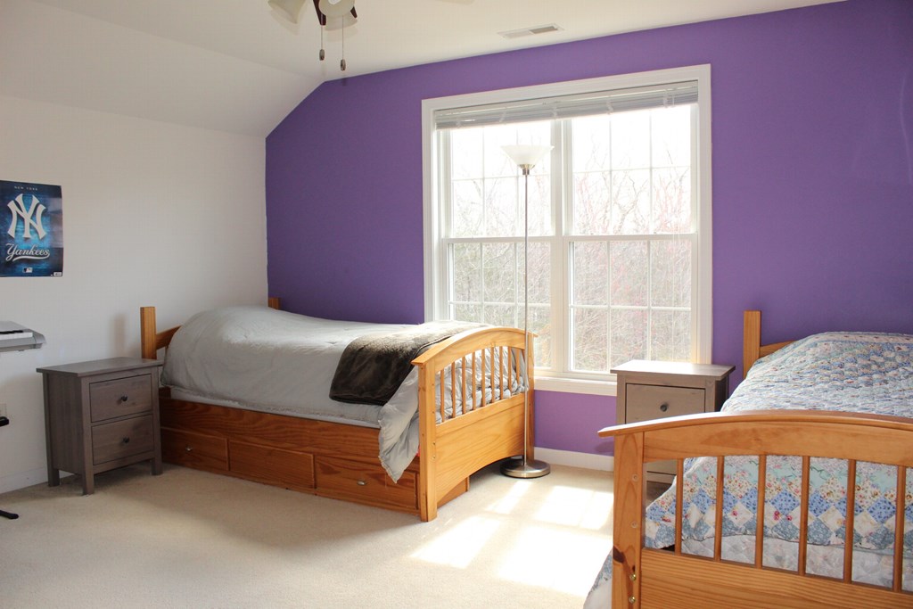101 Buttercup Lane, Unit 101 Grafton, MA 01560 - Photo 19 of 24 a bedroom with a bed and a window