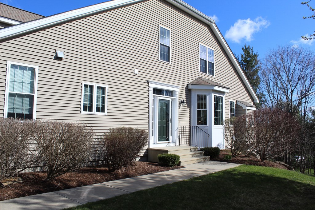 101 Buttercup Lane, Unit 101 Grafton, MA 01560 - Photo 2 of 24 a view of a white house with yard and windows