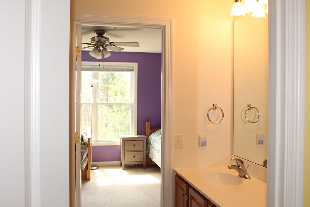 101 Buttercup Lane, Unit 101 Grafton, MA 01560 - Photo 21 of 24 a en suite bathroom with a granite countertop sink and a mirror