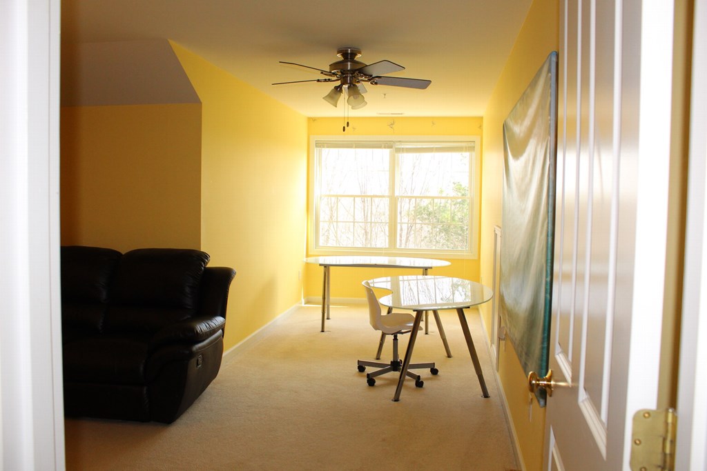 101 Buttercup Lane, Unit 101 Grafton, MA 01560 - Photo 22 of 24 a living room with a chair and a large window
