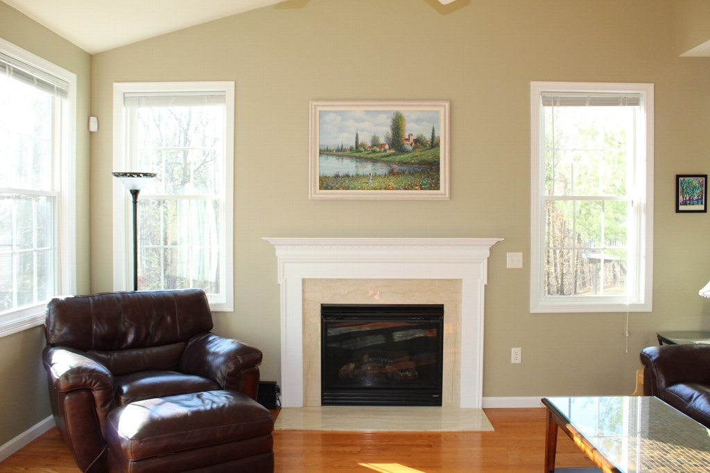 101 Buttercup Lane, Unit 101 Grafton, MA 01560 - Photo 3 of 24 a living room with furniture a window and a fireplace