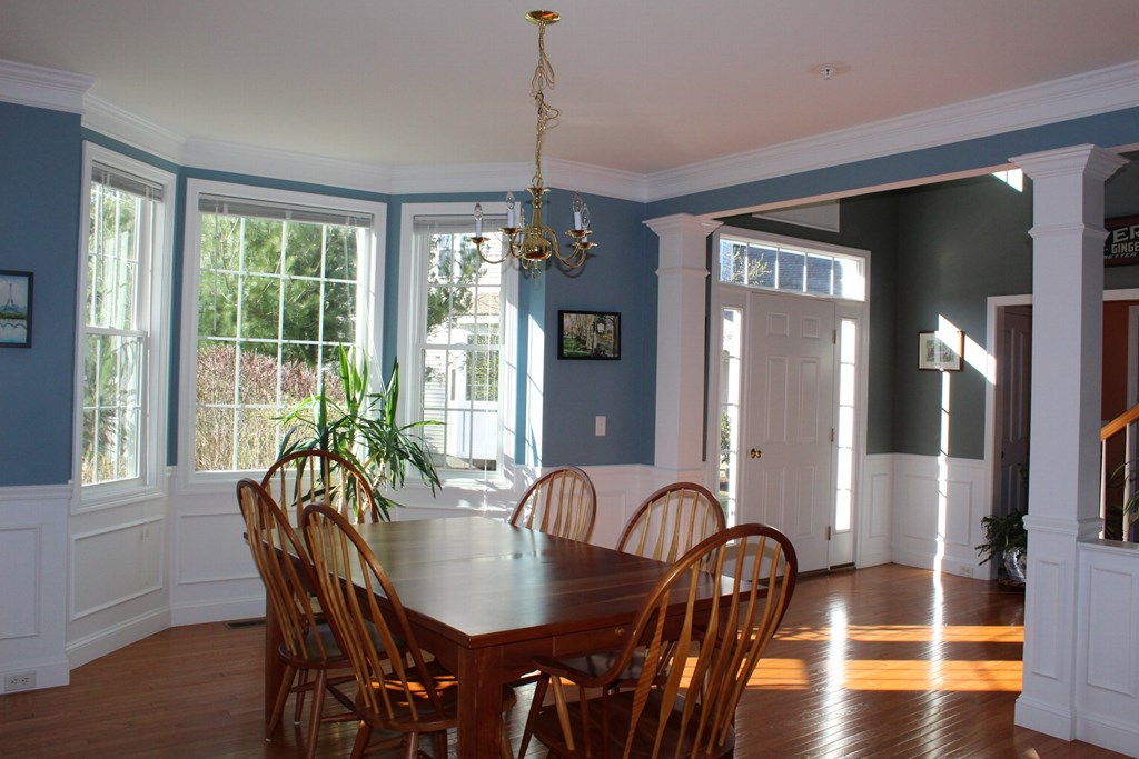 101 Buttercup Lane, Unit 101 Grafton, MA 01560 - Photo 7 of 24 a view of a a dining room with furniture window and wooden floor