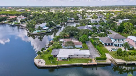 an aerial view of residential houses with outdoor space and swimming pool