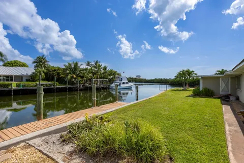 a view of a lake with a house in the background