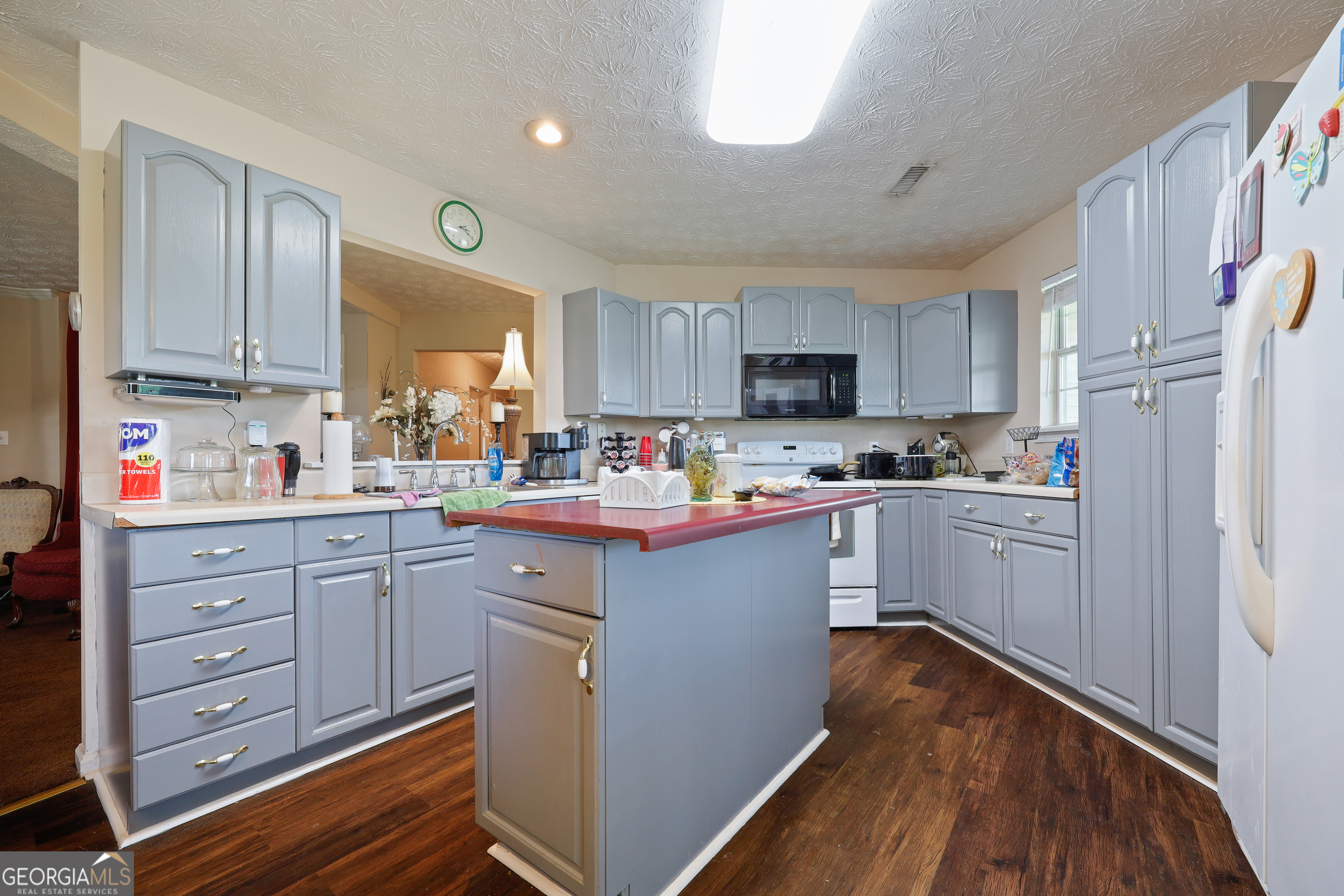 2433 Bear Creek Road Statham, GA 30666 - Photo 12 of 58 a kitchen with stainless steel appliances sink refrigerator and cabinets