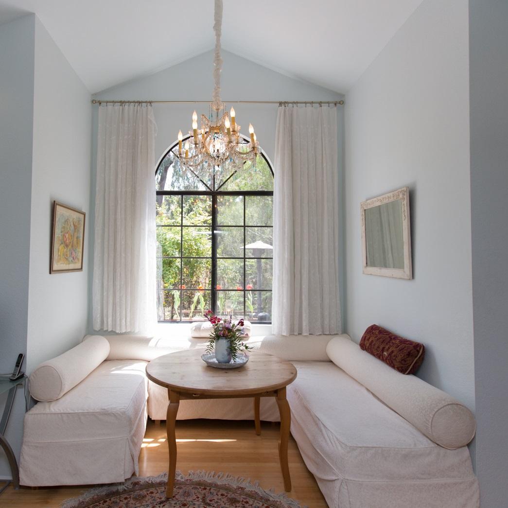 a living room with furniture and a chandelier