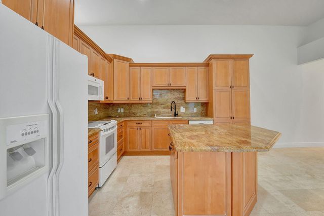 a kitchen with stainless steel appliances granite countertop a sink and cabinets