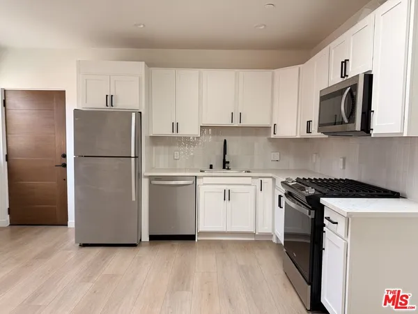 a kitchen with a refrigerator stove and microwave