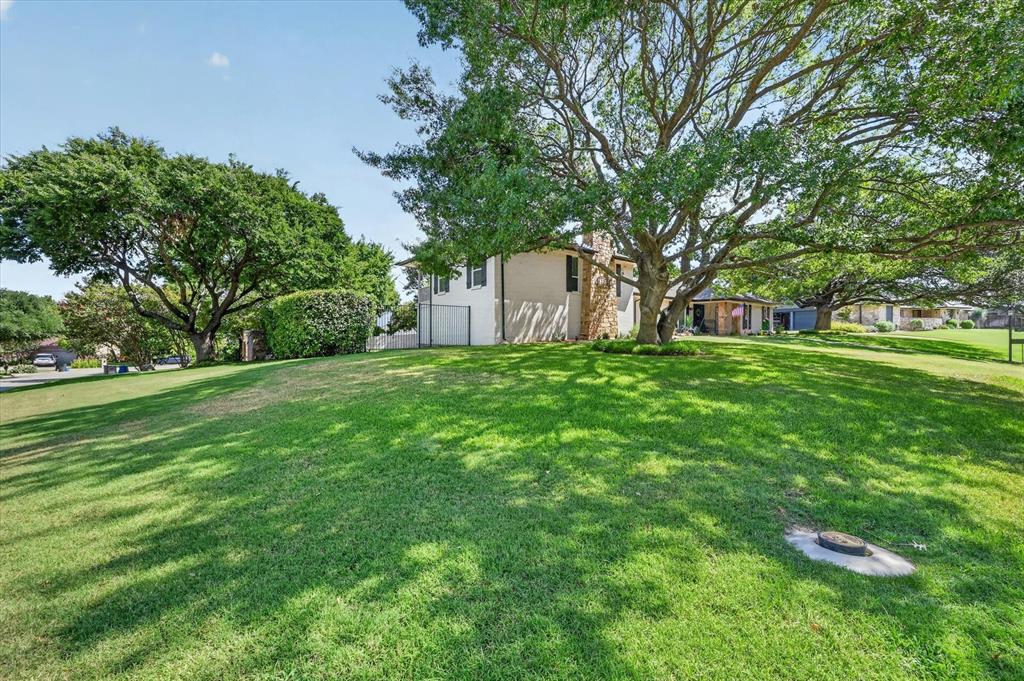 47 Bounty Road East Benbrook, TX 76132 - Photo 39 of 39 Expansive front yard with a generous grassy slope and mature trees providing natural shade