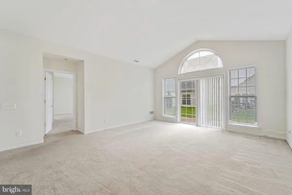 an empty room with windows and entrance