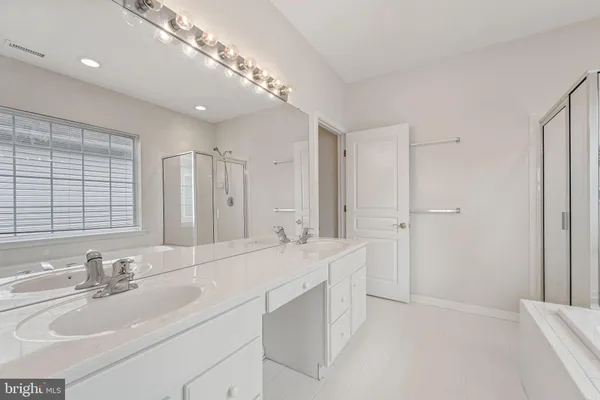 a bathroom with a double vanity sink mirror and double