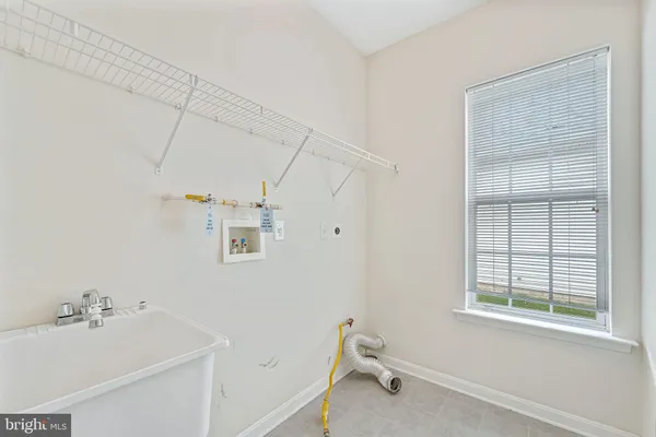 a bath room with a window and a bath tub