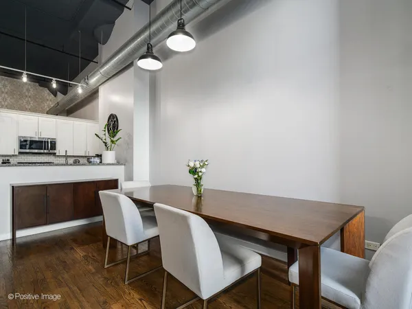 a kitchen with granite countertop a refrigerator stove and microwave