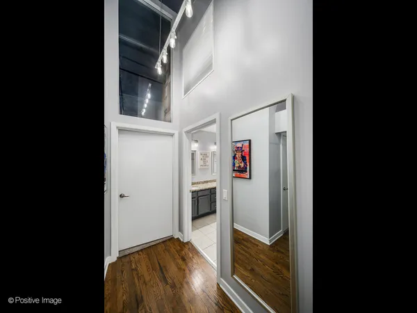 a bedroom with a bed and painting on the wall