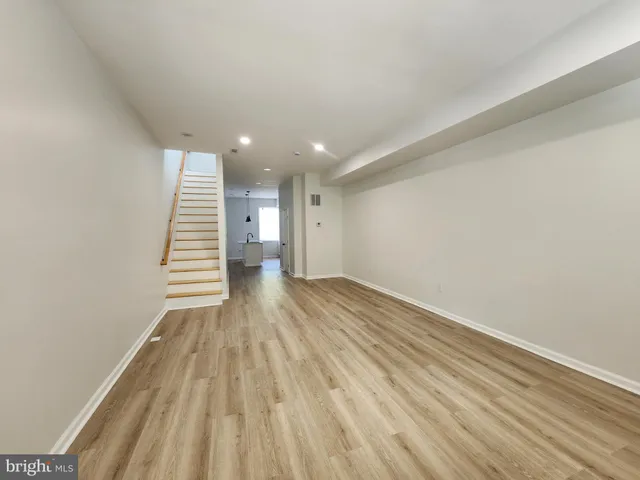a view of a room with wooden floor and stairs