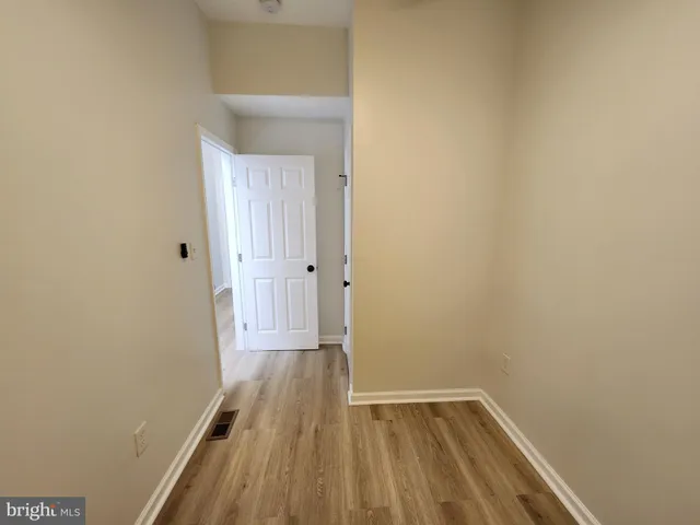 a view of a small space with wooden floor