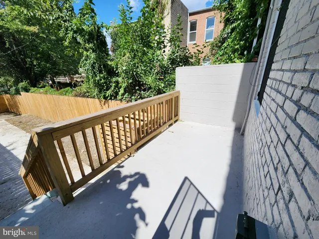 a view of balcony with wooden floor and fence