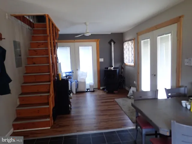 a view of a livingroom with wooden floor and stairs