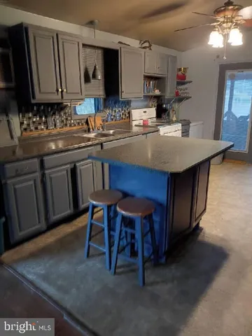 a kitchen with a sink cabinets and window