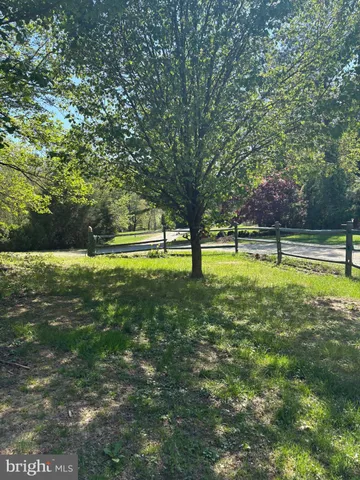 a view of outdoor space with deck and yard