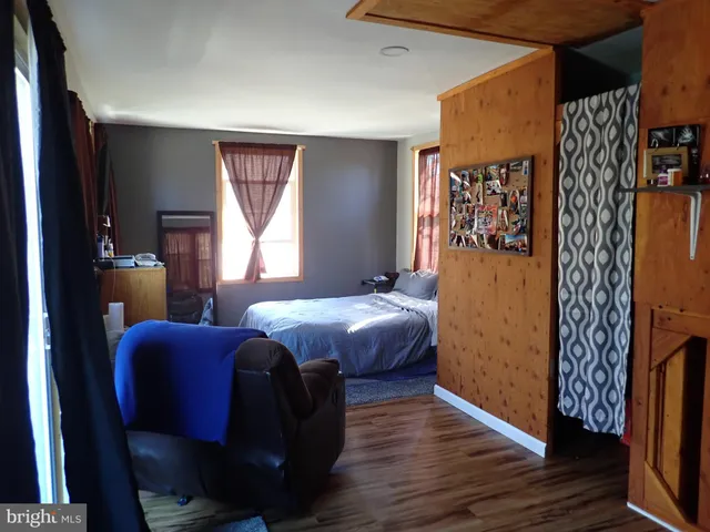 a bedroom with furniture and a window