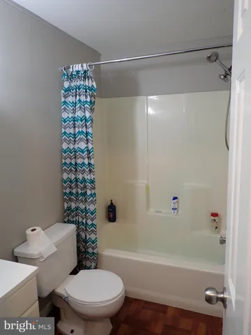 a bathroom with a toilet and a bathtub