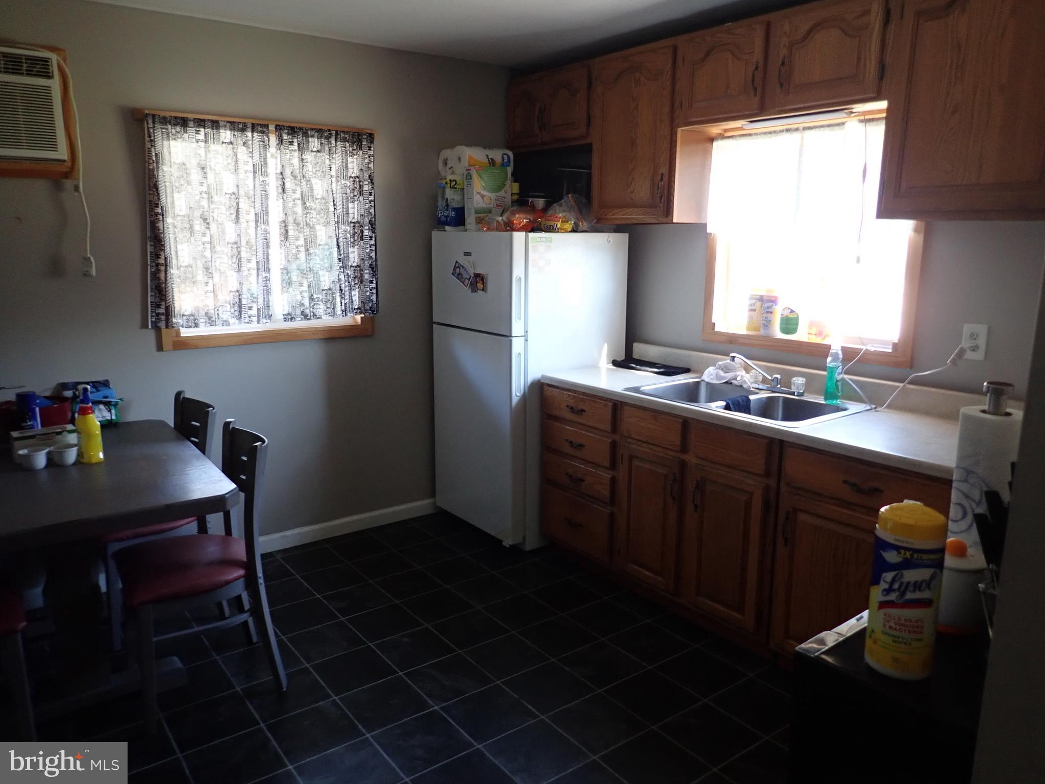 230 McKinneytown Road North East, MD 21901 - Photo 10 of 27 a kitchen with stainless steel appliances granite countertop a sink a stove a refrigerator wooden floor and a dining table