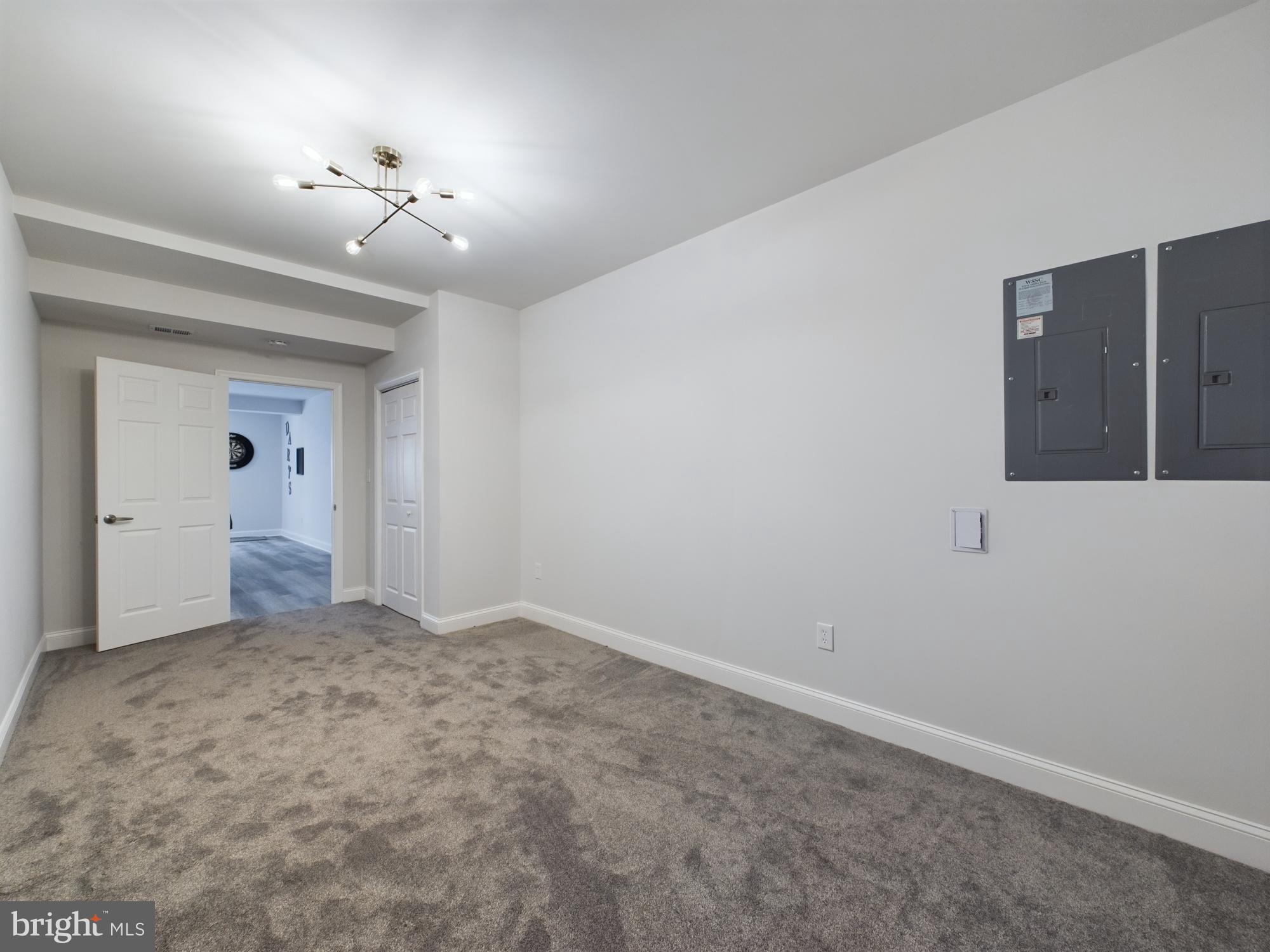 14601 Driftwood Road Bowie, MD 20721 - Photo 63 of 90 Spacious room with modern lighting design.