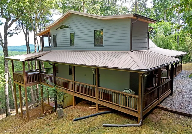 a view of a house with wooden fence