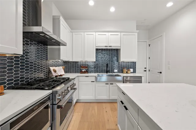 a kitchen with a sink a stove and cabinets