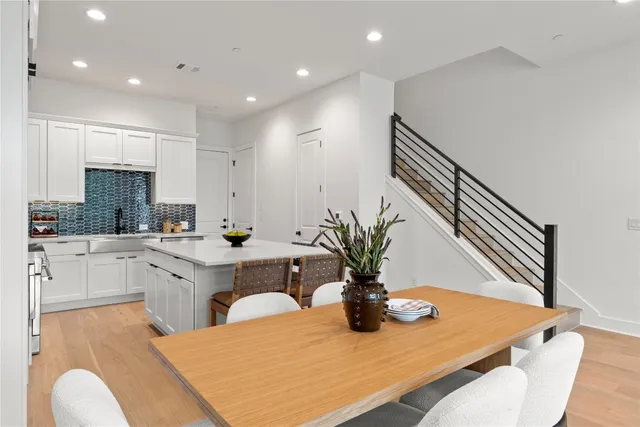 a kitchen with sink and view of living room