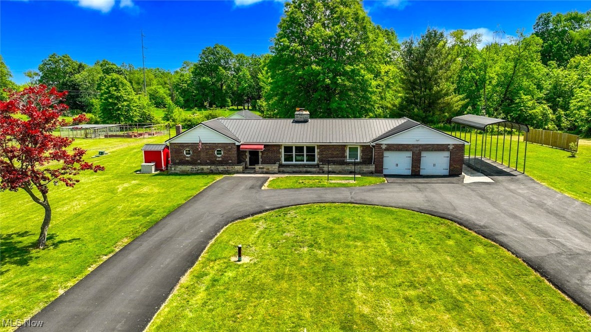 4597 Rock Cut Road Barberton, OH 44203 - Photo 1 of 44 *WELCOME HOME! 4597 ROCK CUT IN NORTON, OH. BRICK RANCH W/3 BDRMS, 1BA, FINISHED BASEMENT, REMODELED KITCHEN, DOUBLE ATTACHED GARAGE, PAVED WRAP AROUND DRIVEWAY, RV COVERED CARPORT, EXTRA OUTBUILDING/GARAGE/BARN, GENERATOR, GARDEN ON 4.3 ACRES OF LAND! WOW
