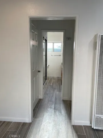 a view of a hallway with wooden floor