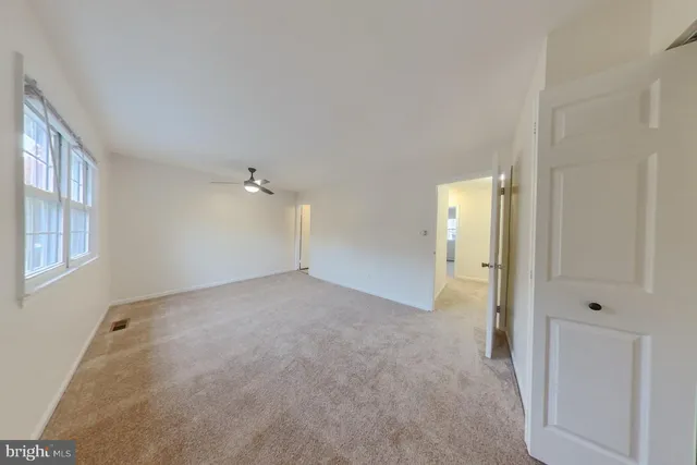 an empty room with windows and closet