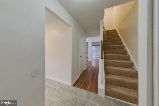a view of a hallway with wooden floor and entryway