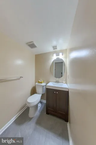 a bathroom with a sink toilet and mirror
