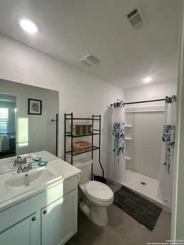 a bathroom with a toilet and a shower curtain