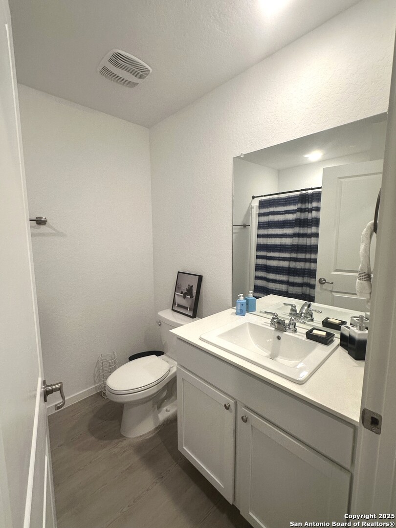 515 Lew Pass San Antonio, TX 78221 - Photo 5 of 26 a bathroom with a sink a toilet and mirror