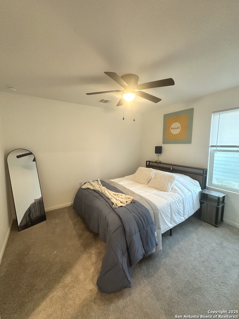515 Lew Pass San Antonio, TX 78221 - Photo 8 of 26 a bedroom with a bed and a chair